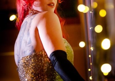 Shot of Burlesque Artist Kelly Ann Doll in a gold dress modelling for Dr Sketchy's Sydney
